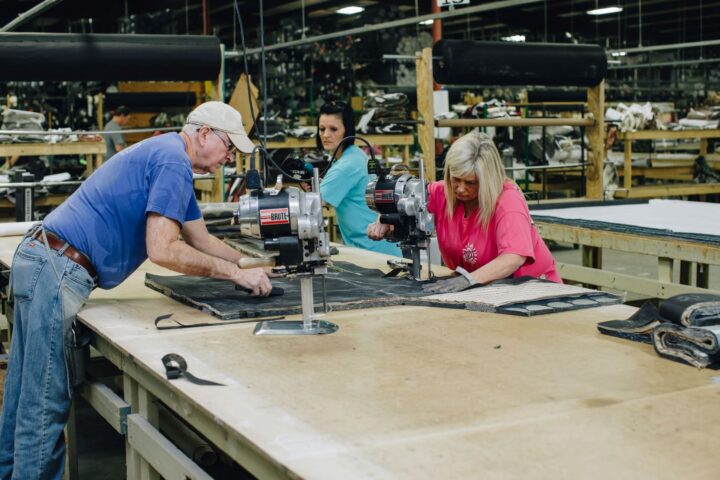 Fusion Furniture employees sewing fabrics together