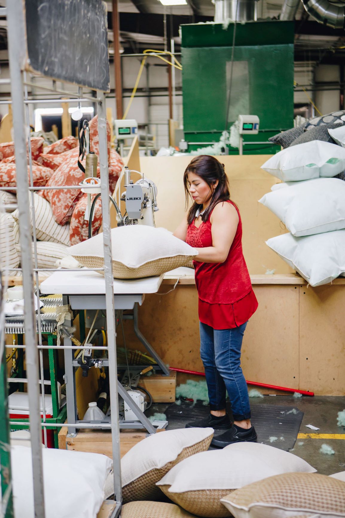 Fusion Furniture employee stuffing pillows