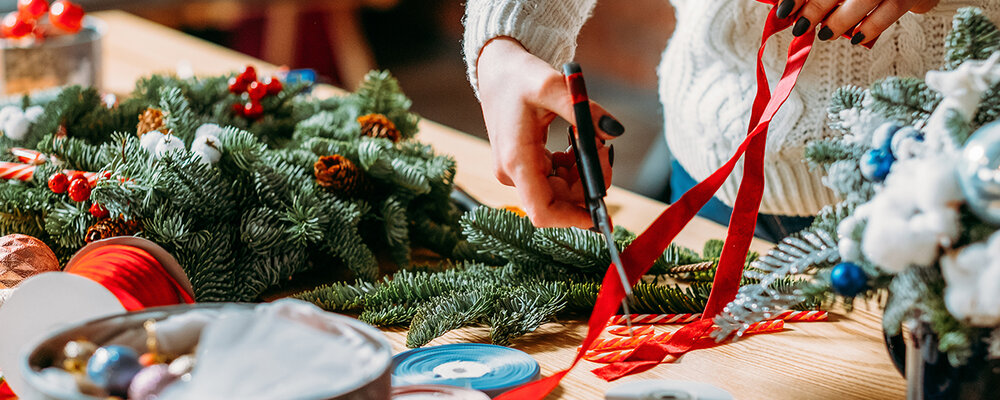 Woman crafting up Christmas decor idea