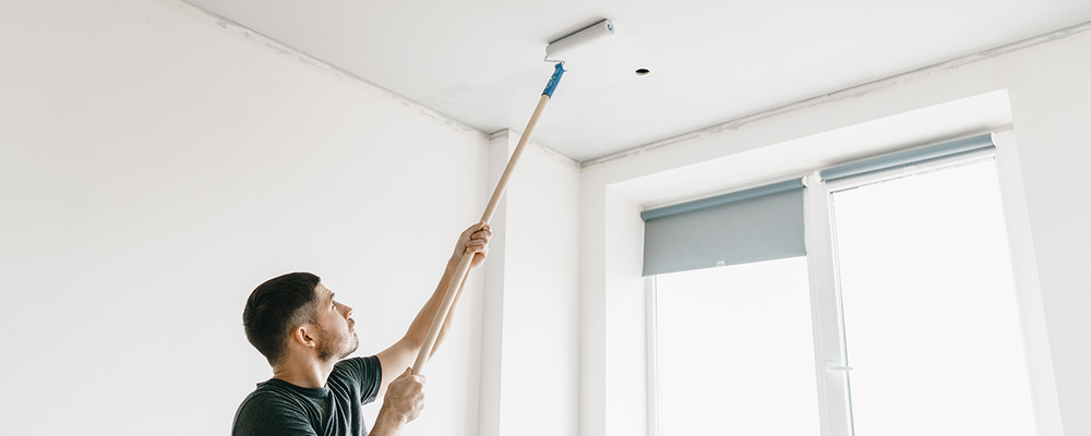 Man painting ceiling