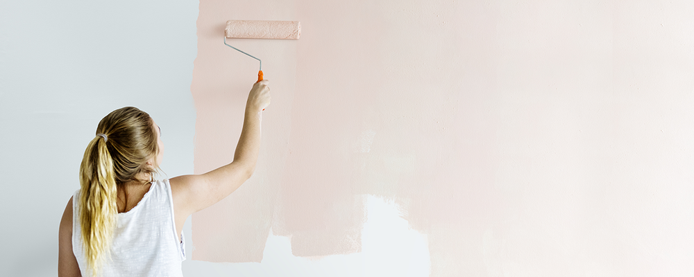 Woman painting walls of home