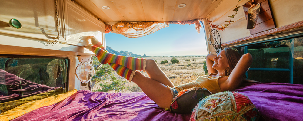 Woman relaxing in travel van