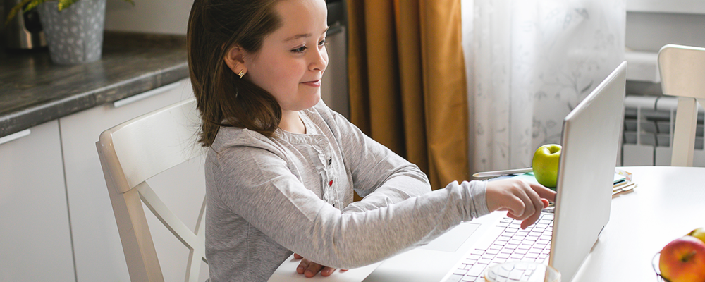 Young girl learning in classroom at home