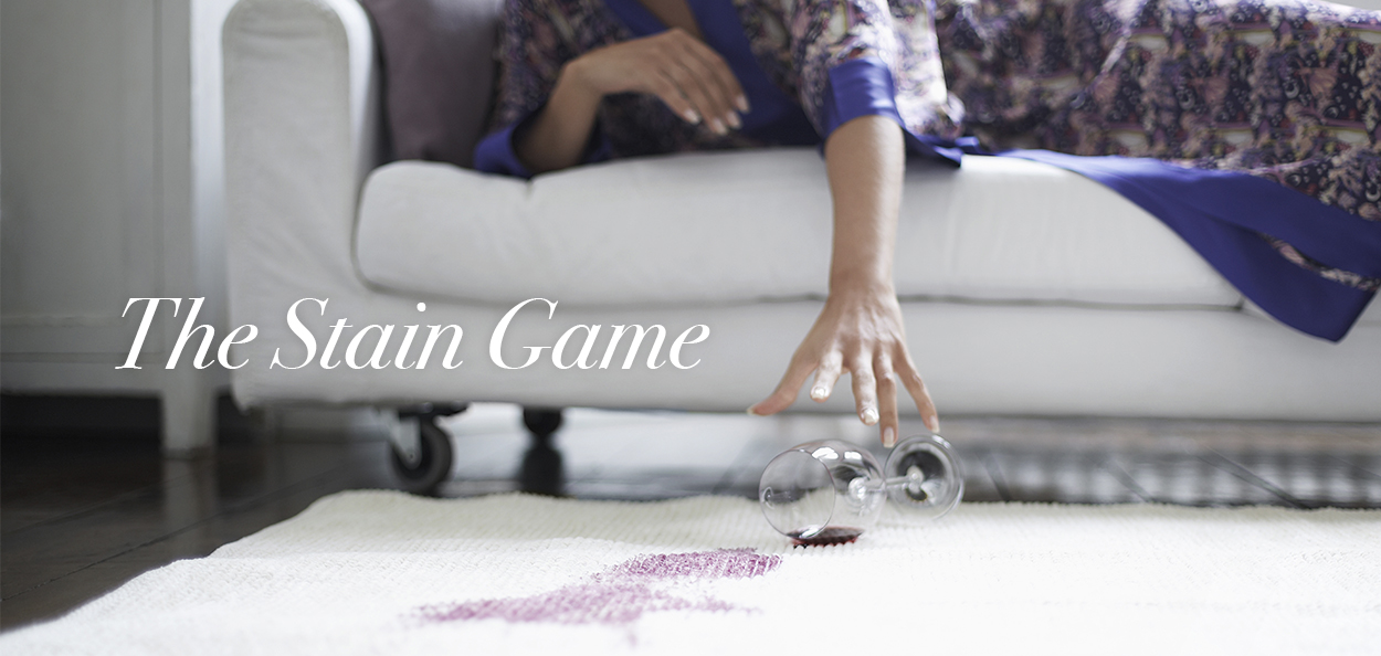 Woman spilling wine on carpet