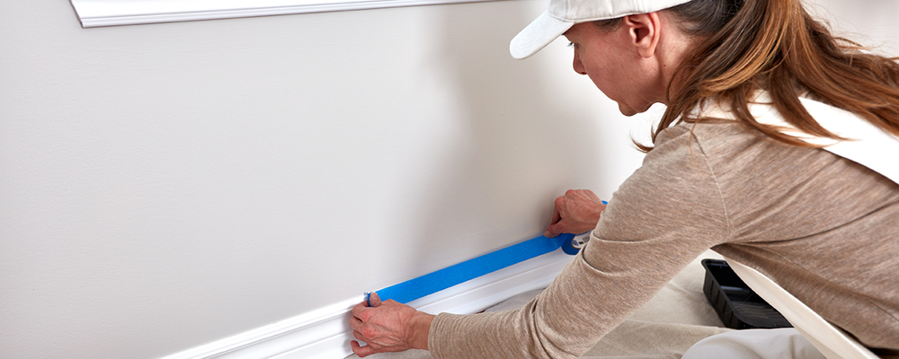 Woman applying painter’s tape