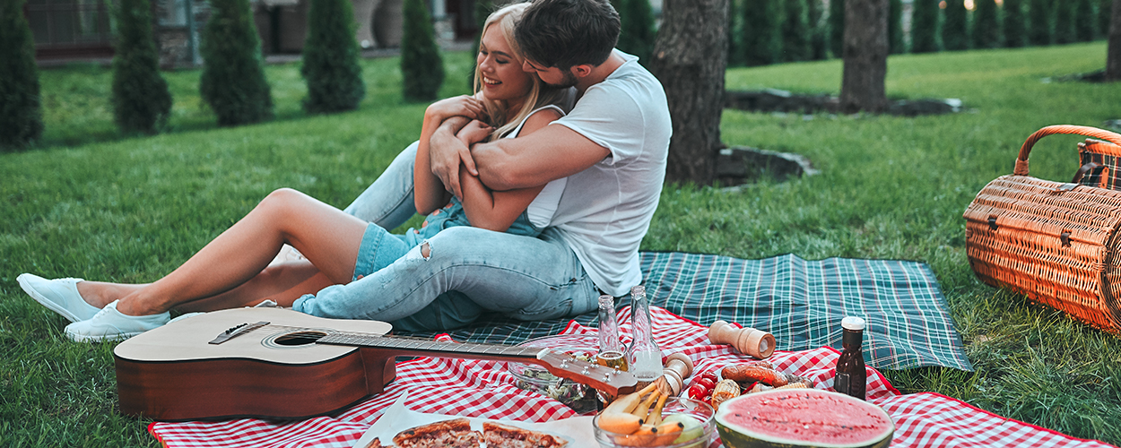 Couple enjoying backyard picnic for Valentine’s Day at home