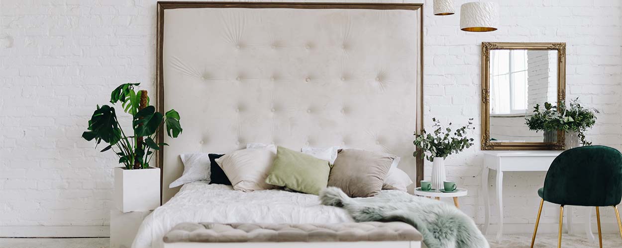 Oversized headboard in large bedroom