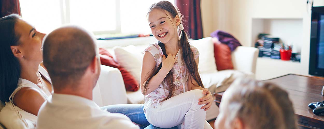 Parents and children hanging out in family room 